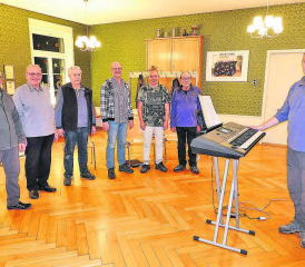Der Männerchor Burg mit Dirigent Lubomir Rachunek ganz rechts: Die gesellige (wegen Abwesenheiten aber nicht ganz komplette) Runde, gönnt sich in der Singpause auch mal ein Gläschen Wein.