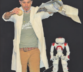 Experiment mit Zeitung und Holzkugel: Professor Bummbastic wurde assistiert von seinem Roboter im Hintergrund. (Bild: st.)