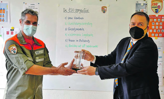 Übergabe auf Distanz: SZSV-Vorstandsmitglied Michel Elmer (rechts) übergibt den Pokal an Kommandant Gregor Müller. (Bild: zVg.)