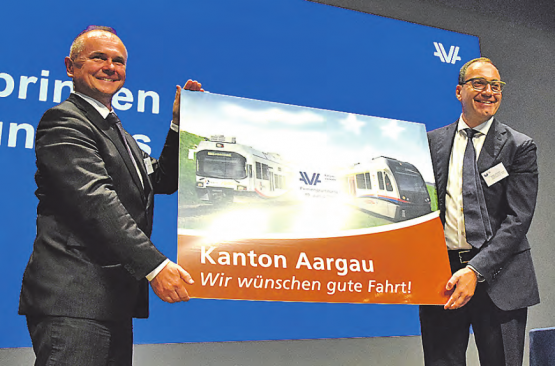 Freude über die Neugründung: Severin Rangosch, der Chef von «Aargau Verkehr» (links), und Verwaltungsratspräsident Kaspar Hemmeler freuen sich über das von Regierungsrat Stephan Attiger überreichte Bild zur Fusion von WSB und BDWM. (Bilder: zVg.)