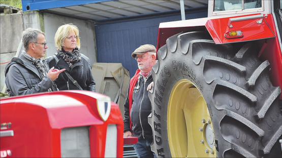 Die Räder sind grösser als der Besitzer des Traktors: Peter Bachmann (re.) im Gespräch mit einem Kirchleerauer Unternehmerpaar. (Bilder: st.)